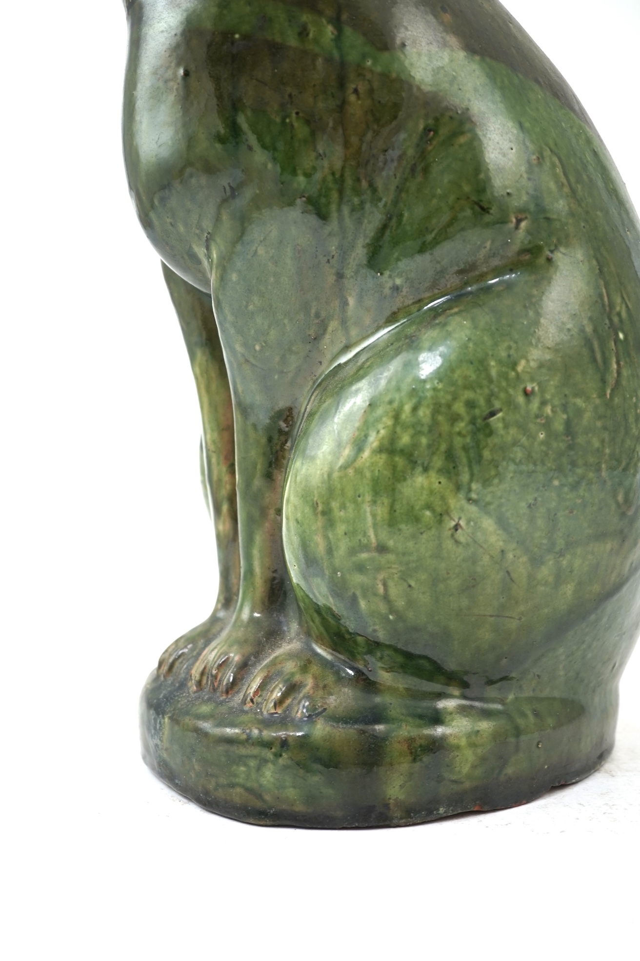 Ewenny Pottery: A large green-glazed figure of a seated cat